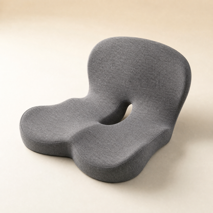 The Serenzo Atlas seat cushion in mid grey, shown at a three-quarter angle on a warm bone background